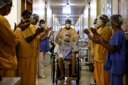 69-year-old patient greets on discharge from hospital in Porto Alegre, Brazil (Reuters)